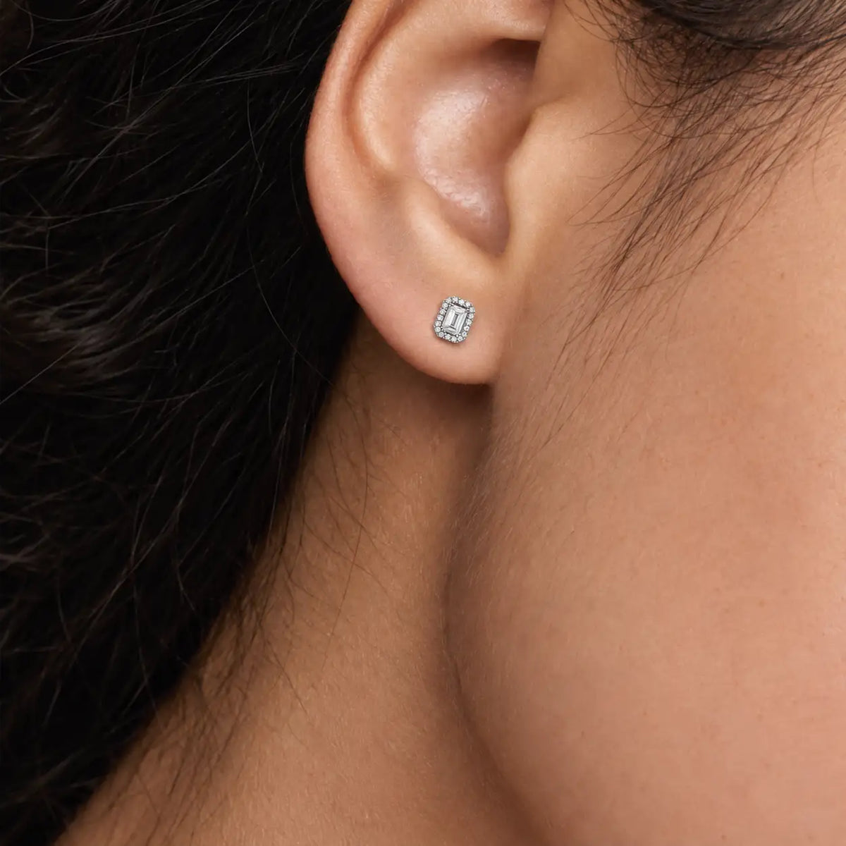 Woman wearing 1ct Emerald-Cut Lab Grown Diamond Halo Stud Earrings by Fortune Jewellery