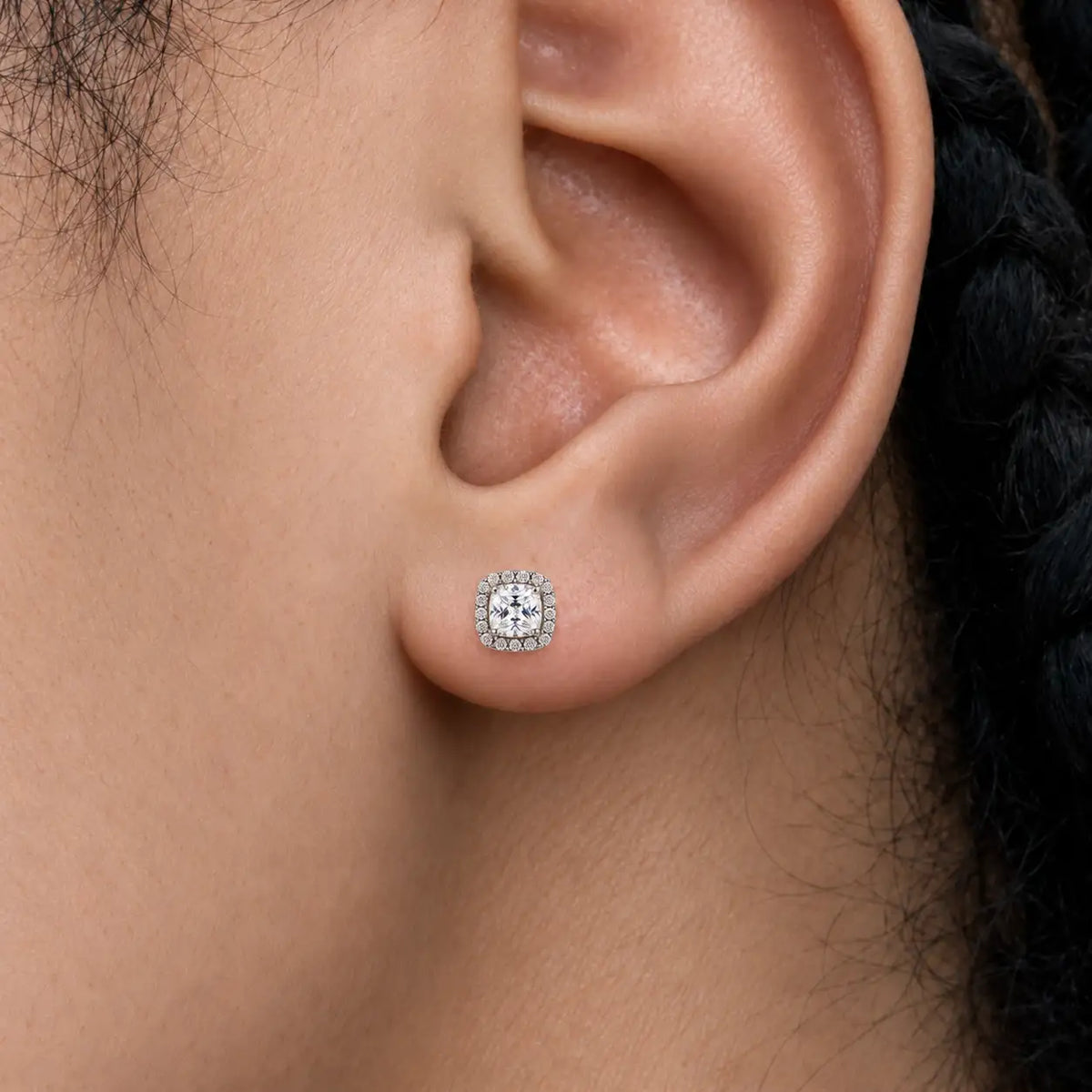 Close-up view of woman wearing 1.5ct Cushion-Cut Lab Grown Diamond Halo Stud Earrings