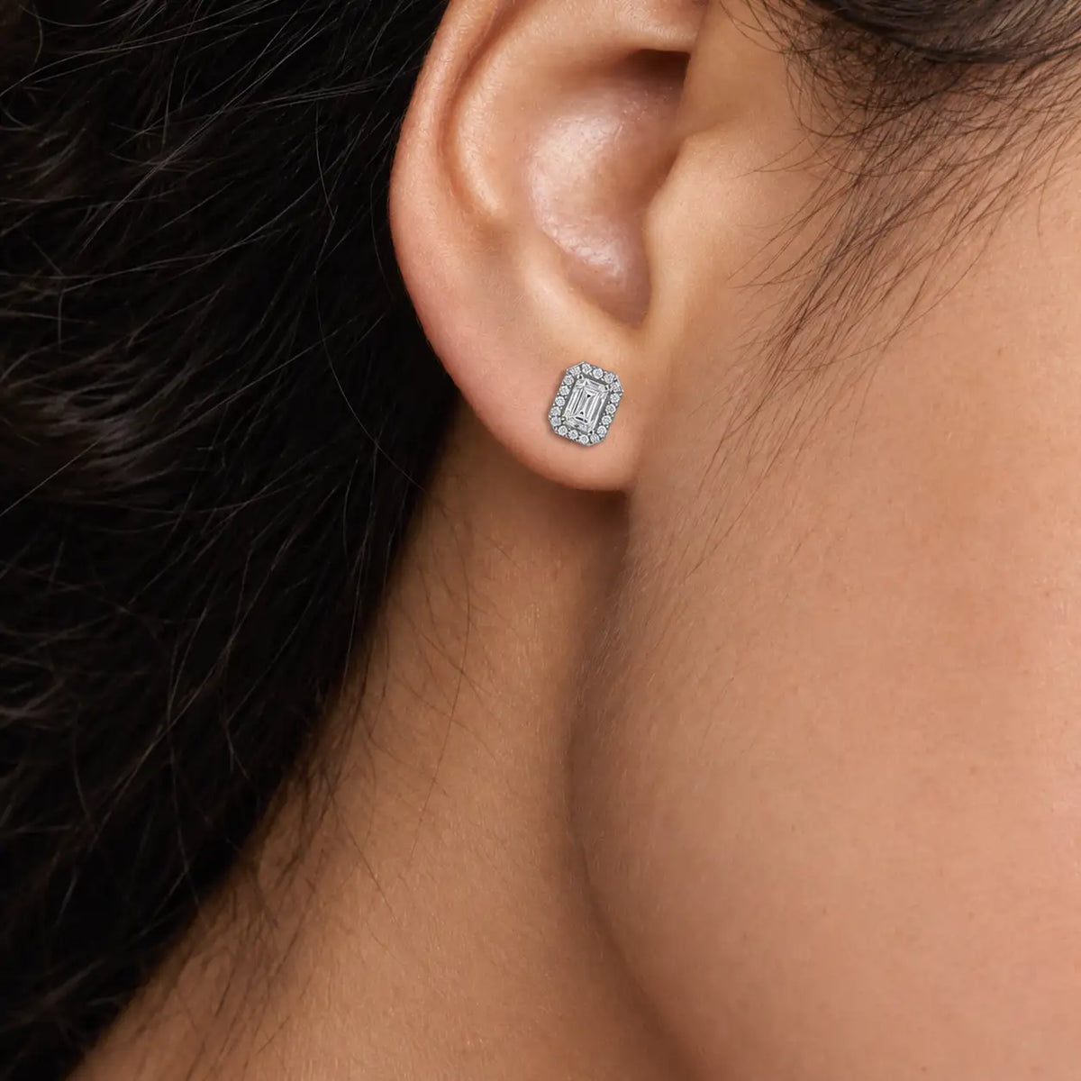 Woman wearing 8ct Emerald-Cut Grand Halo Diamond Stud Earrings by Fortune Jewellery