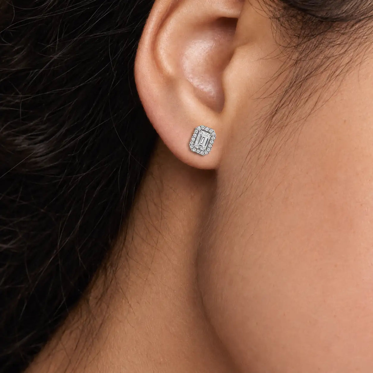 Woman wearing 10ct Emerald-Cut Diamond Halo Stud Earrings by Fortune Jewellery