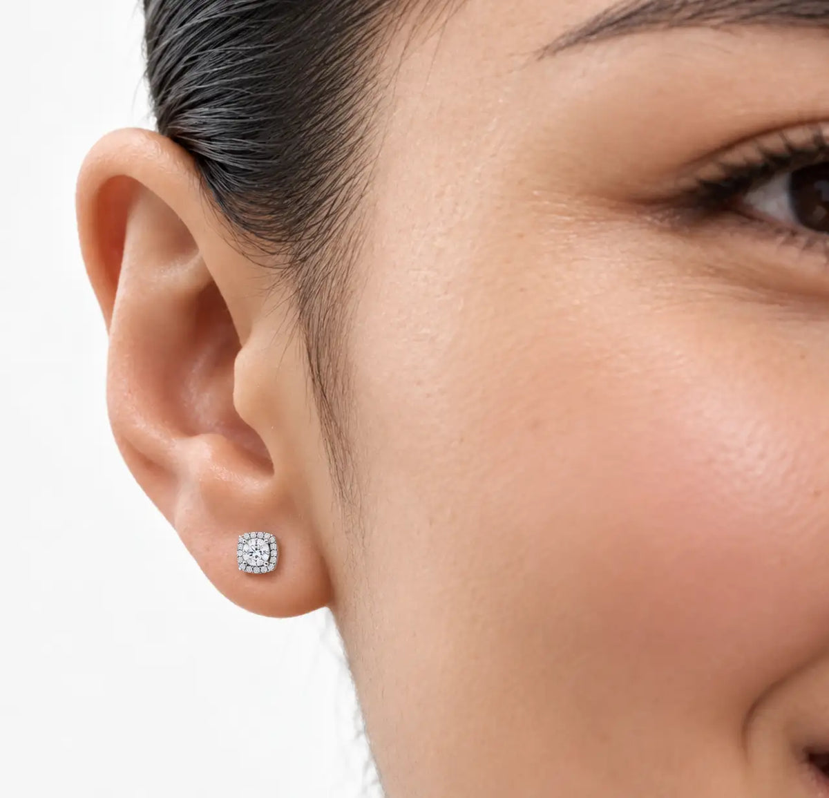Woman wearing 1ct Cushion-Cut Lab Grown Diamond Halo Stud Earrings