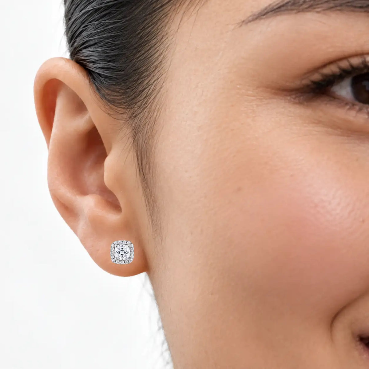 Woman wearing 8ct Elegant Cushion-Cut Lab Grown Diamond Halo Earrings for bridal styling
