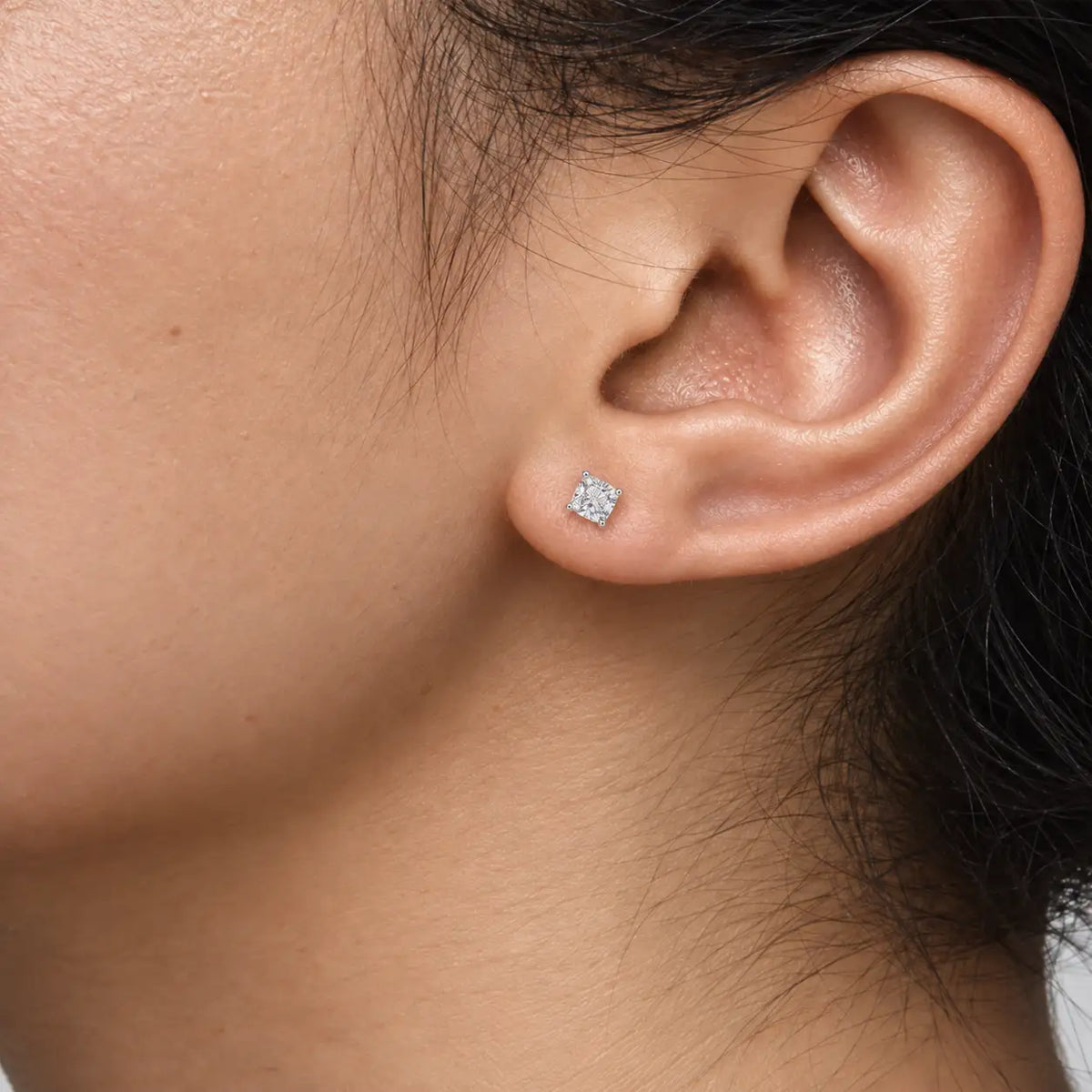 Woman wearing 2ct Cushion-Cut Lab Diamond Solitaire Stud Earrings by Fortune Jewellery