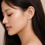 Model wearing pear frost diamond hoops for office wear
