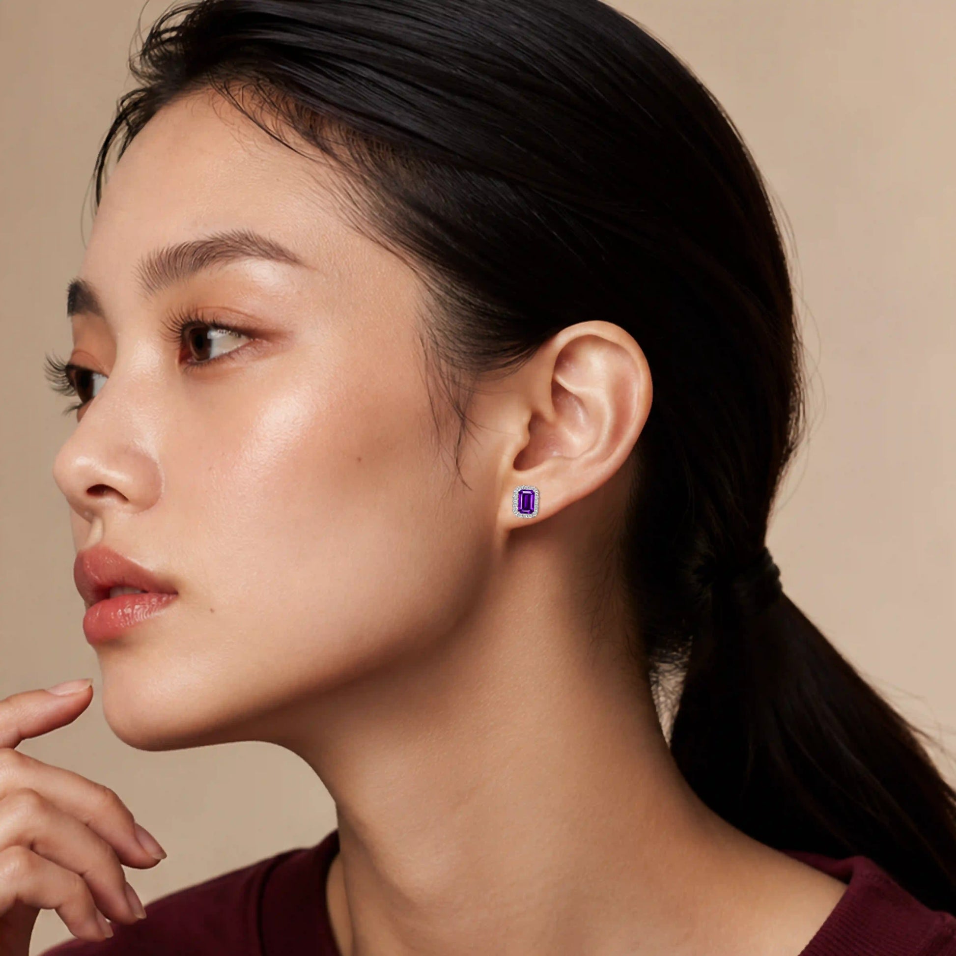 Model wearing white gold february birthstone amethyst earrings with diamonds