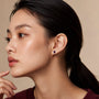 Model wearing white gold january birthstone garnet earrings with diamonds