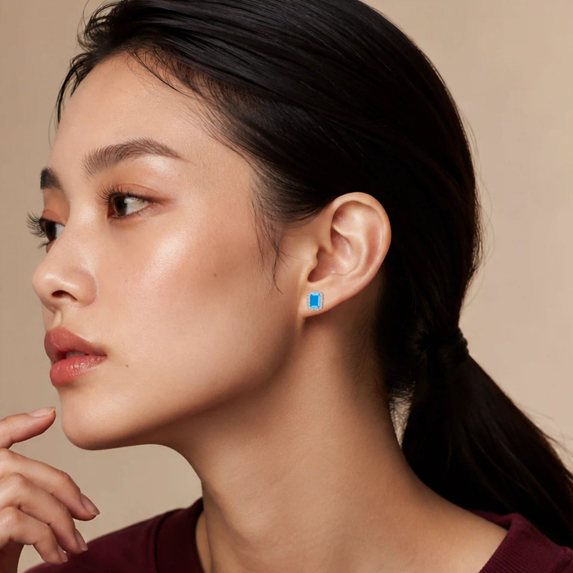 Model wearing white gold unique december birthstone turquoise earrings with diamonds