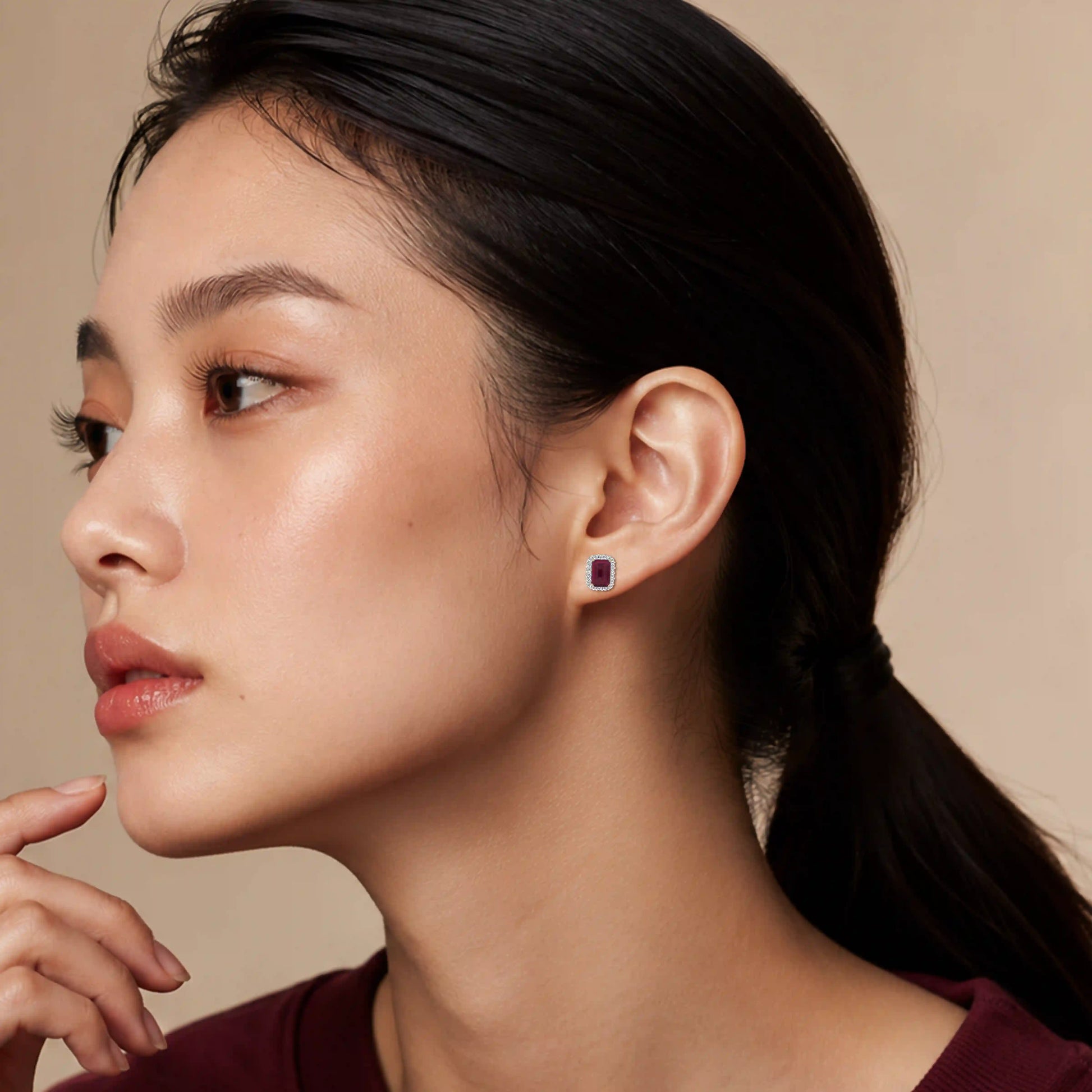 Model wearing yellow gold january birthstone garnet earrings with diamonds