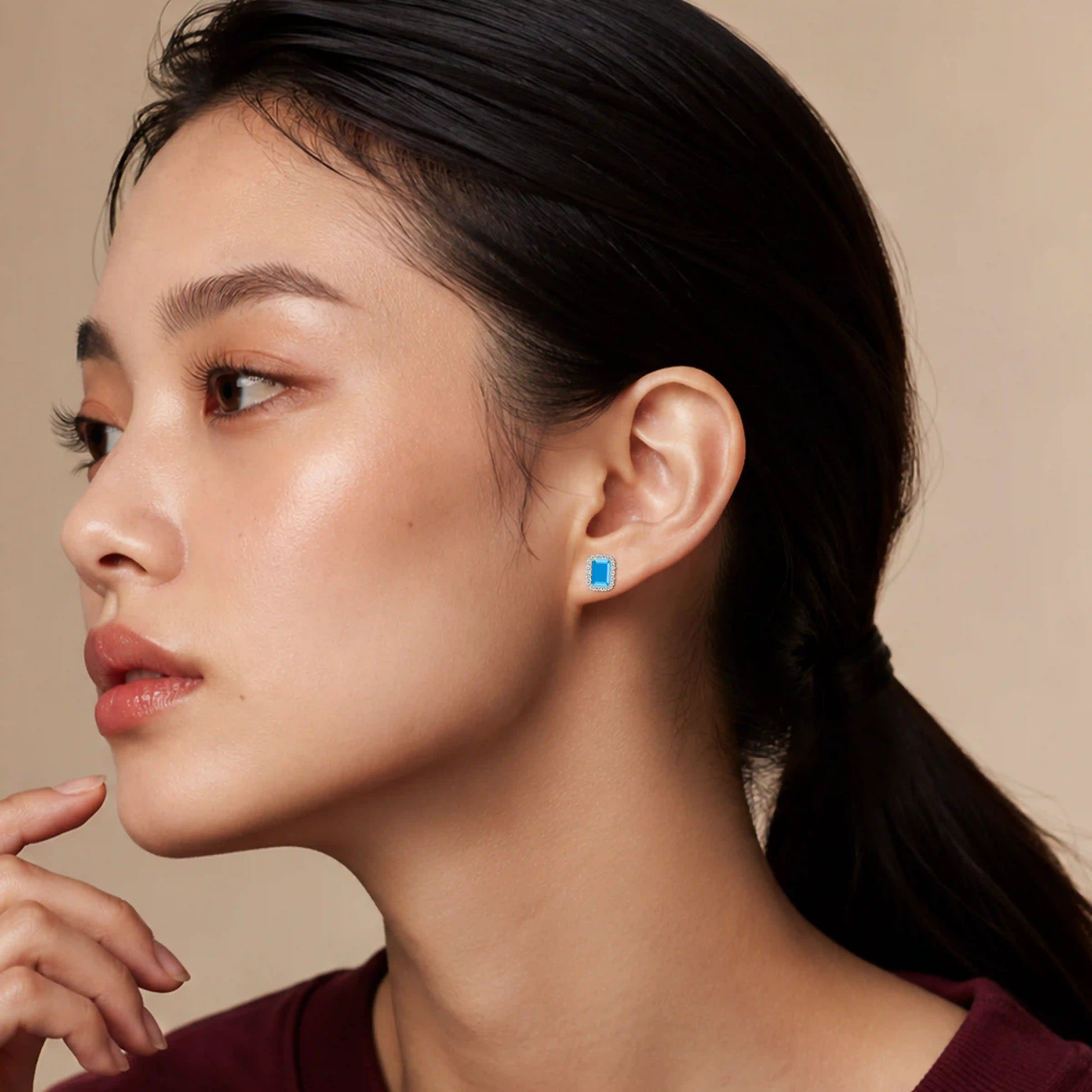 Model wearing yellow gold unique december birthstone turquoise earrings with diamonds