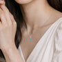 Model wearing december birthstone pear-shaped turquoise and diamond pendant