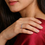 Woman wearing a February Birthstone Amethyst Rhythm Ring With Diamonds