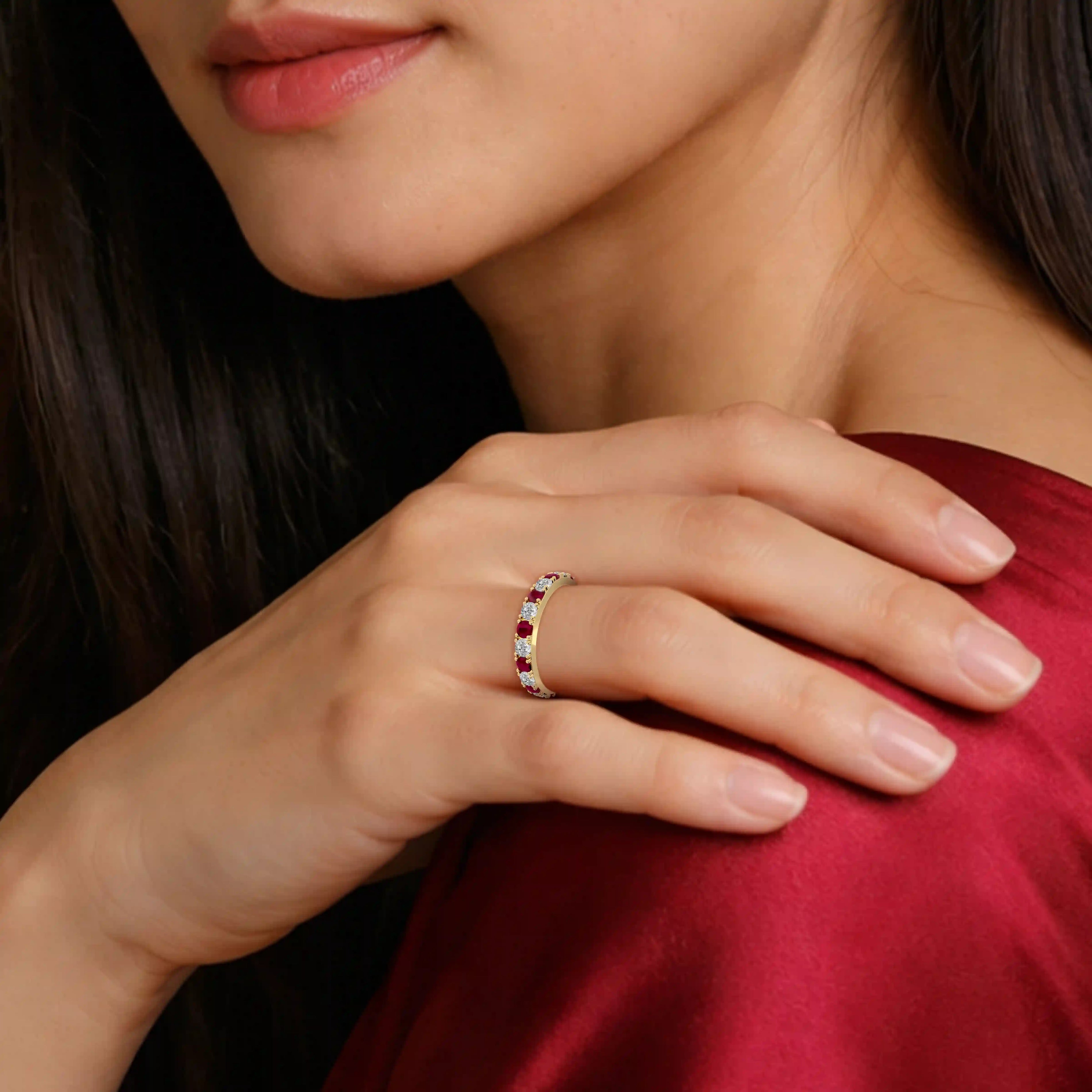 Close-up of a woman's hand wearing a January Birthstone Garnet Rhythm Ring With Diamonds