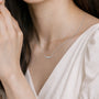 Model wearing baguette & round diamond scatter bar necklace