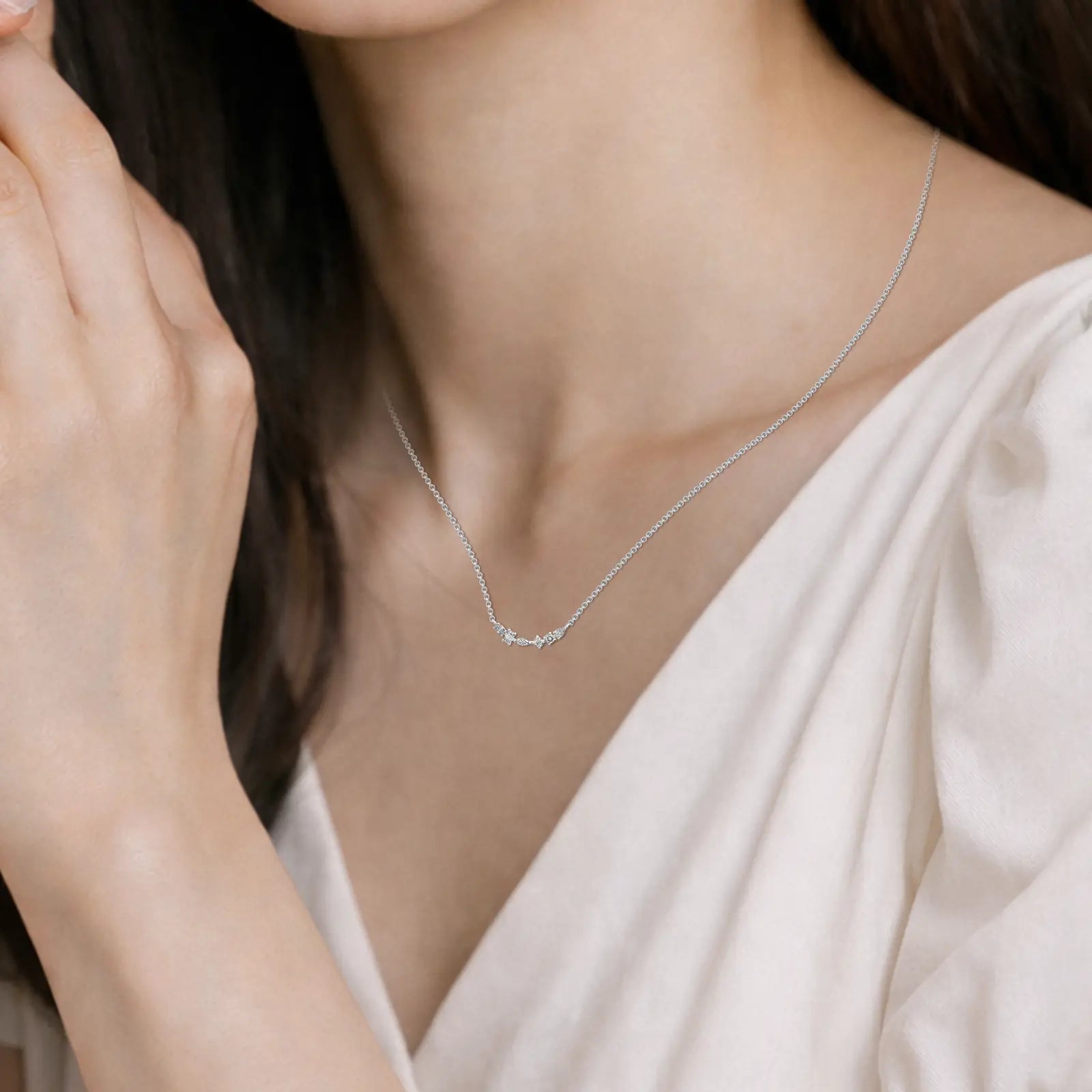 Model wearing Multi-cut diamond curved bar necklace