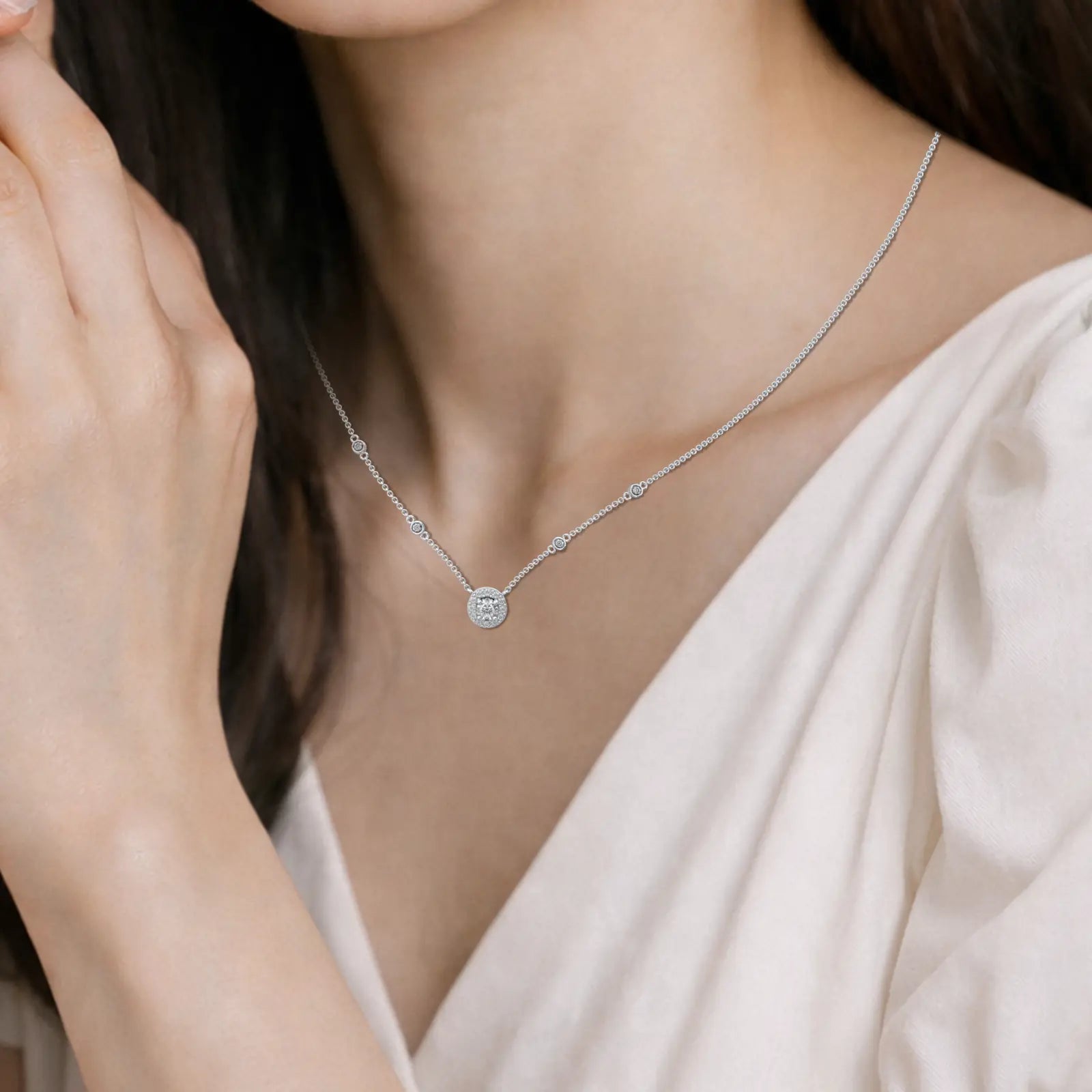 Model image of celestia round diamond halo and bezel station necklace